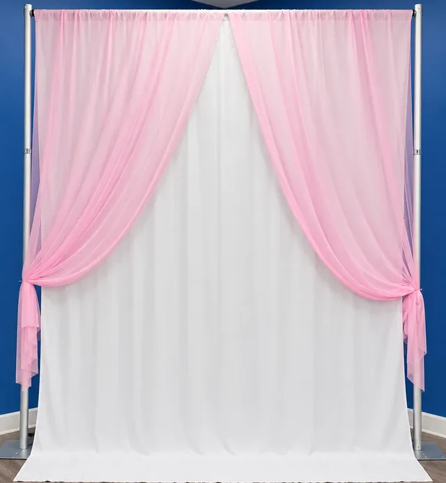 Pink sheer drapes tied back over white